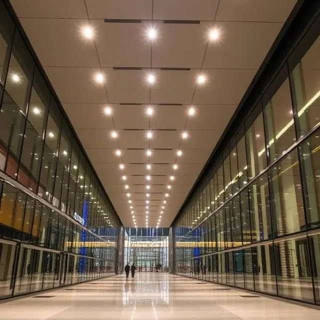LED Lighting Specification for UAE Commercial Project MEP consultant reviewing an LED lighting schedule and floor-plan drawings for a UAE commercial project